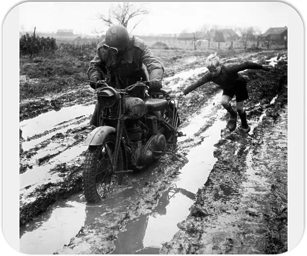World War II Invasion of Holland A British army dispatch rider stuck in the mud gets a