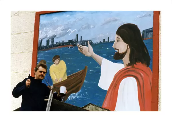 Art student Gary McNamara with the mural he has painted above the entrance to St Pius