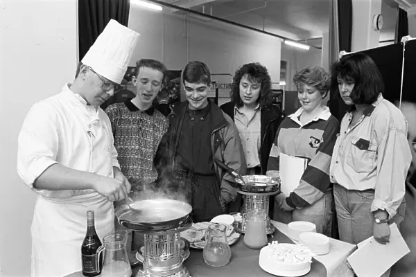Second year student Simon Taylor makes flamb? pancakes in brandy for school pupils