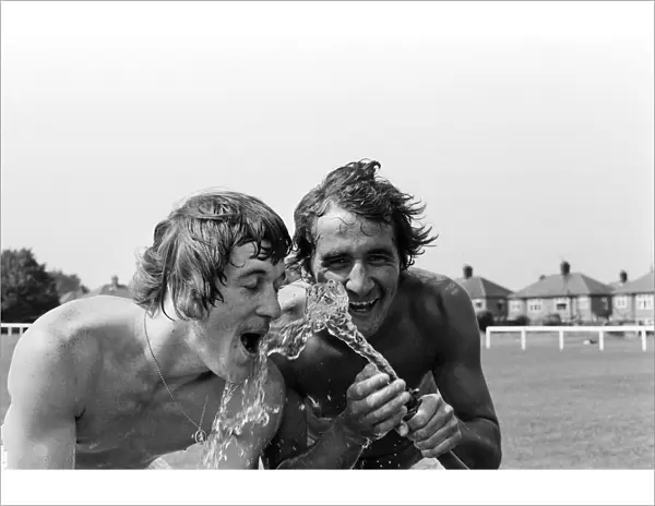 Cooling off after training in a heatwave are Leicester City footballers Steve Kember