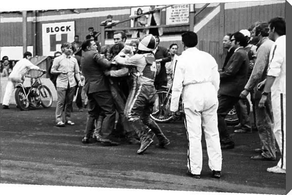 Flare up at Belle Vue. Officials rush in to separate Belle Vue rider Alan Wilkinson