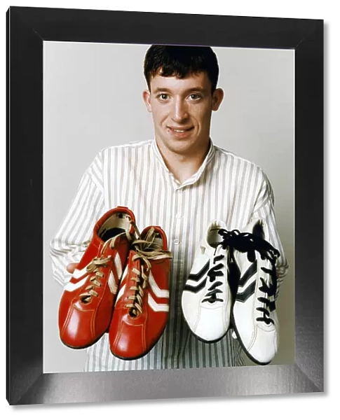 Liverpool teenage sensation Robbie Fowler with 2 pairs of football boots