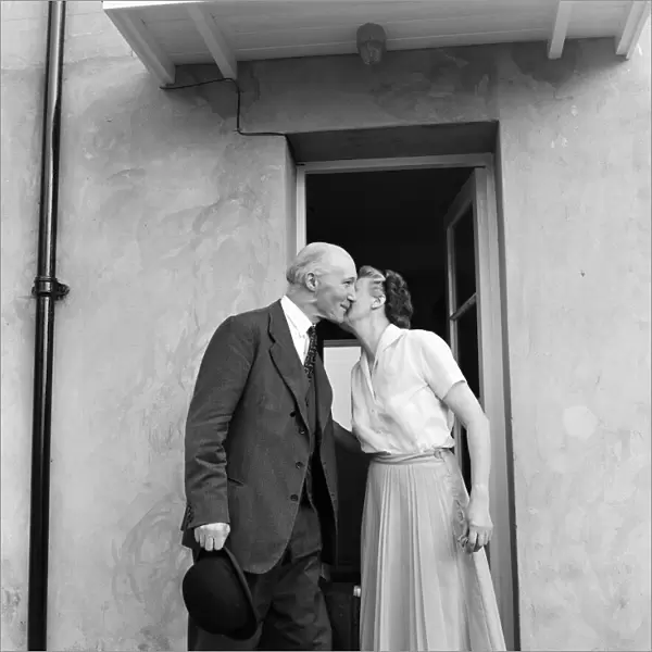Lord Denning kisses his wife at their home in Whitchurch before leaving for London to