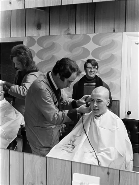 A man getting a 'Kojak'hair cut. 1975