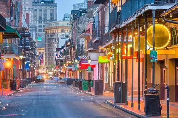 Bourbon St, New Orleans, Louisiana, USA cityscape of bars and restaurants at twilight