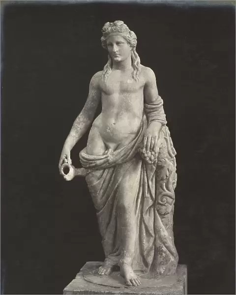 Statue representing Dionysus; work preserved in the Eleusis Museum. The Greek god is semi-naked, leaning on a trunk of a tree with an winding grape vine