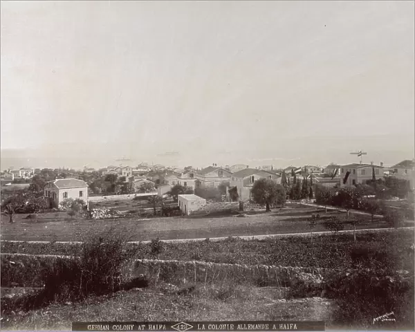 Panorama of the city of Haifa, taken from inland. In the foreground fallow fields. In the background the sea with a few ships at anchor