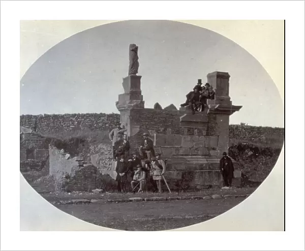 A small group of French and German artists on their way to Naples pose before the ruins of a classical building