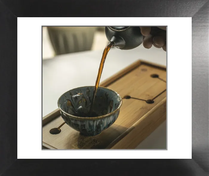 Framed Print : Fragrant Tea Pouring into Handcrafted Cup Print Framed Print : Fragrant Tea Pouring into Handcrafted Cup Print