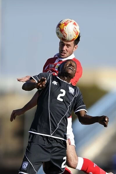 Bristol City's Greg Cunningham vs Extension Gunners Isaac Paete: A Heading Battle in Botswana, 2014
