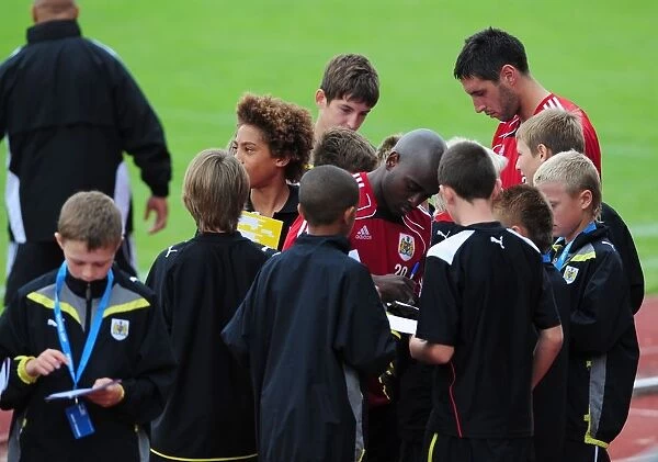 Bristol Citys Jamal Camplbell-Ryce and Bristol Citys Bradley Orr sign autographs for the academy