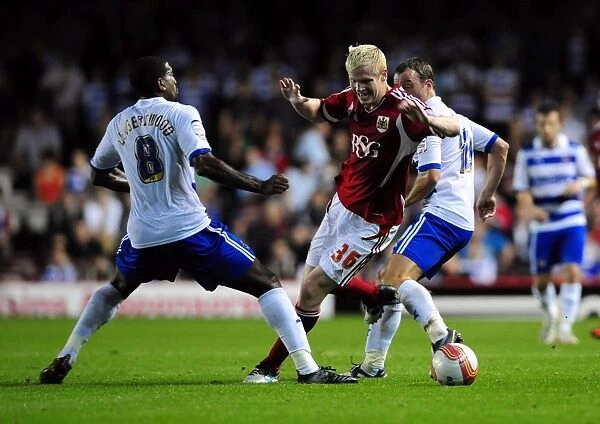 Bristol City's Ryan McGivern Outmaneuvers Mikele Leigertwood and Noel Hunt of Reading in Championship Match, September 2011