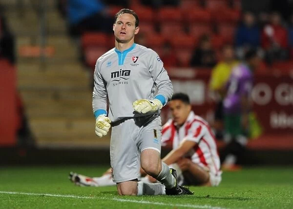 Korey Smith's Goal Mood Swings: Trevor Carson of Cheltenham Town Reacts in Disappointment as Bristol City Celebrates