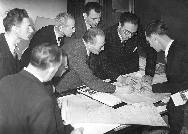 Daily Worker staff examining building alteration plans