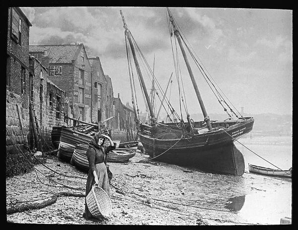 Fishwife at Whitby. A young woman in headscarf and working clothes looks out to sea