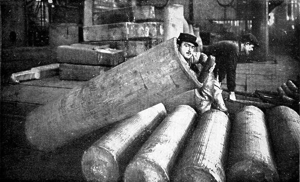 A French soldier lying inside an artillery shell case