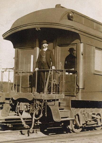 Man at the rear of a railway train, USA