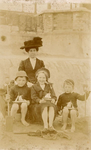 Mother and her three children, each holding a toy boat