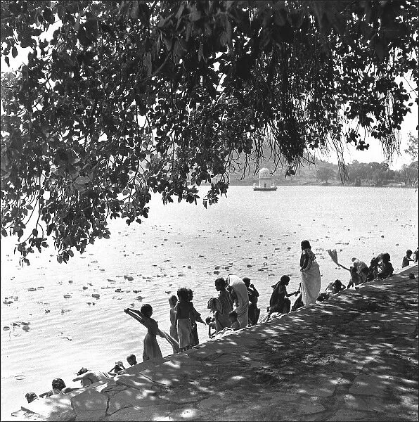 People on a riverbank, India