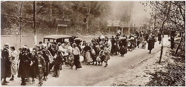 Some of the Republican refugees who fled Spain for France after the fall of Barcelona. Straggling line of women and children marshalled by French Gardes mobiles, while crossing the frontier. Date: January 1939