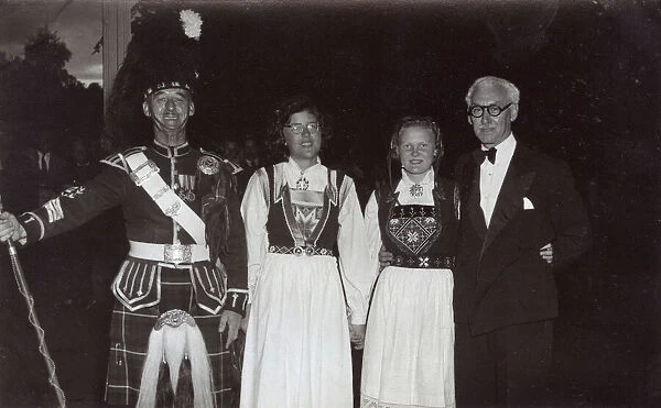 Scotsman in dress uniform with two girls and a man