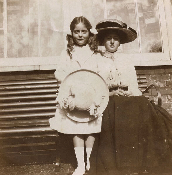 Two sisters on a garden bench