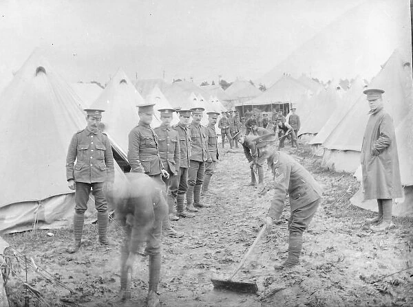 Soldiers cleaning up at a muddy training camp