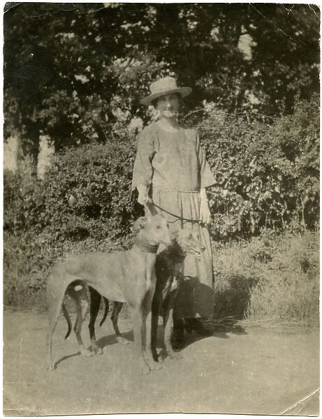 Woman with two dogs on a country lane