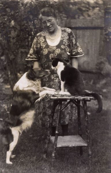 Woman with friendly cat and dog