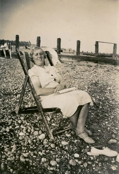 Woman on holiday, sitting in a deckchair