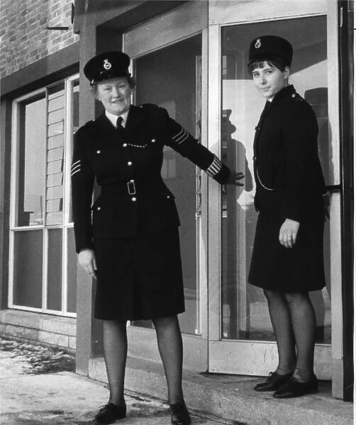 Two women police officers outside a police station