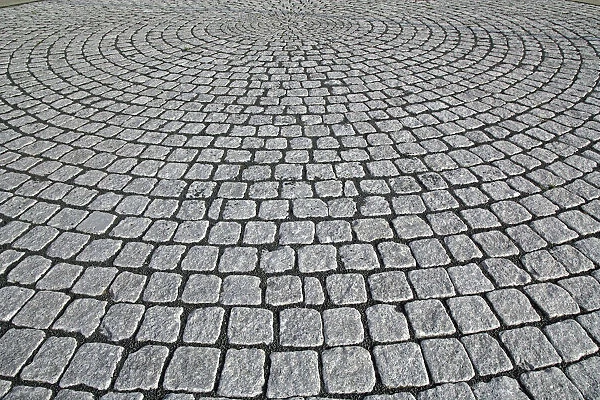 Granite paving laid in a circular pattern. Photographed in Dusseldorf, Germany