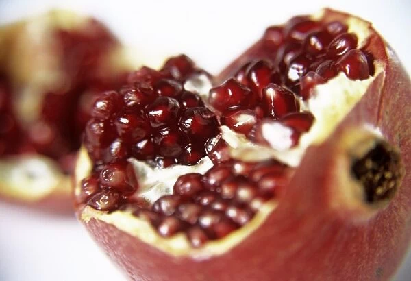 Pomegranate (Punica granatum), torn open to show its seeds