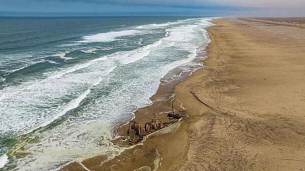 Aerial of a shipwreck on a beach in the Iona National Park, Namibe, Angola, Africa