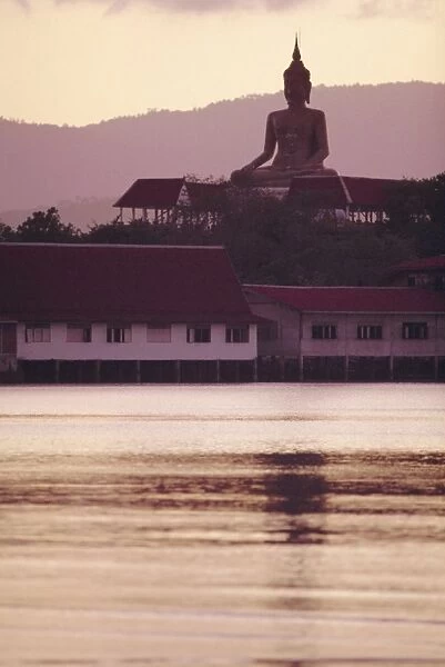 Big Buddha at Koh Faan with Laem Maikaen Cape (hills) in background