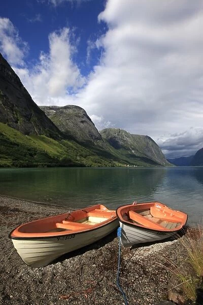 Boats pulled up on the shore of a fjord in the Fjordland region, western Norway, Scandinavia