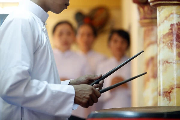 Cao Dai worshipper playing drums, Cao Dai Temple, Phu Quoc, Vietnam, Indochina