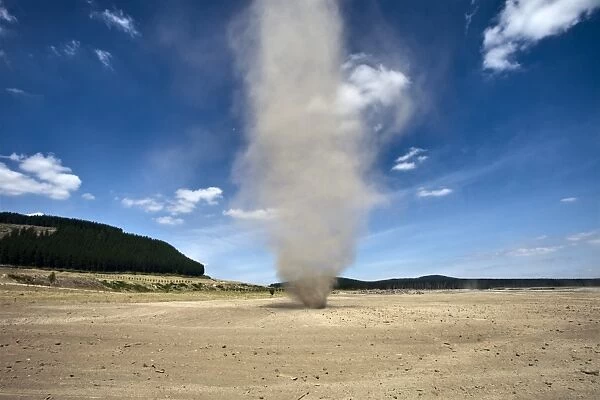 Dust whirlwind twister during summer drought on farm