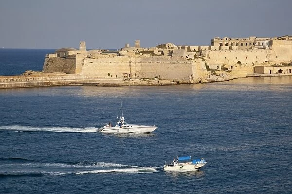 Fort Ricasoli from Valletta, with yacht and water taxi passing, Malta, Mediterranean