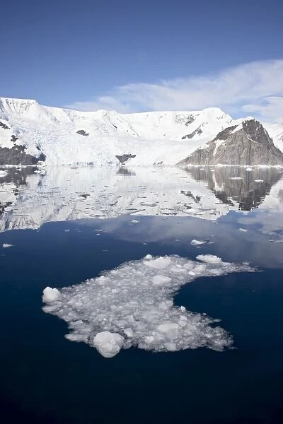 Ice in Neko Harbor with glaciers and snow-covered mountains, Antarctic Peninsula