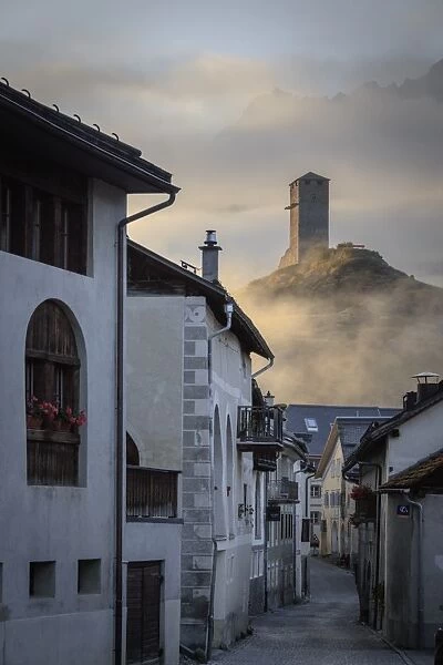 Misty sky on the alpine village of Ardez at sunrise, canton of Graub?nden, district of Inn
