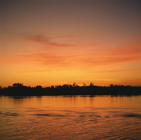 The River Nile at sunset, water reflecting evening sky, in Egypt, North Africa, Africa
