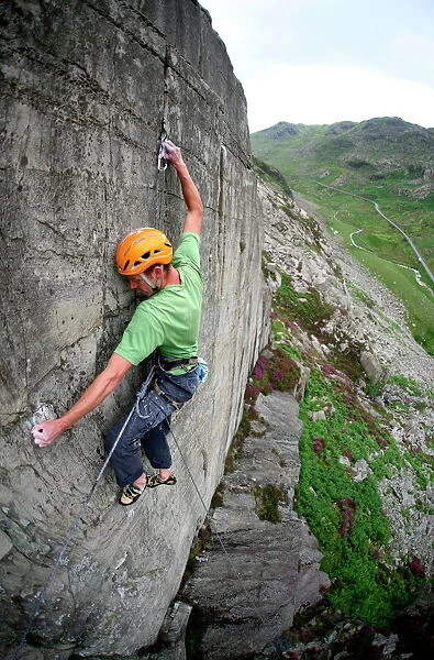 A rock climber makes a first ascent of on the cliffs above the Llanberis Pass