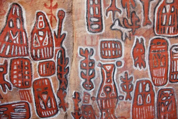 Sacred rock paintings on cliff depicting Dogon customs and stories in Songo