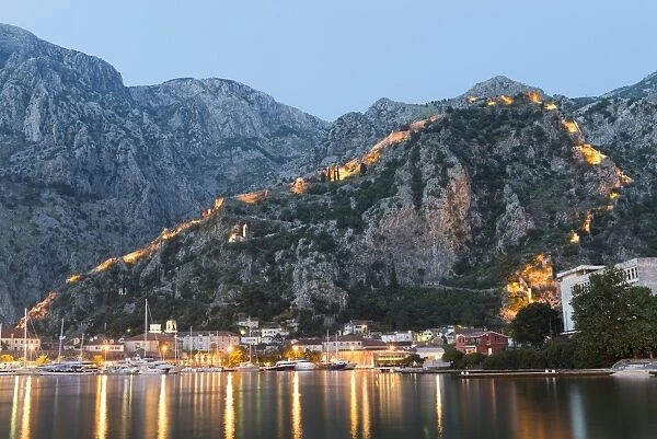 Venetian built fort with bastions highlighted by lights at twilight, Kotor, Montenegro