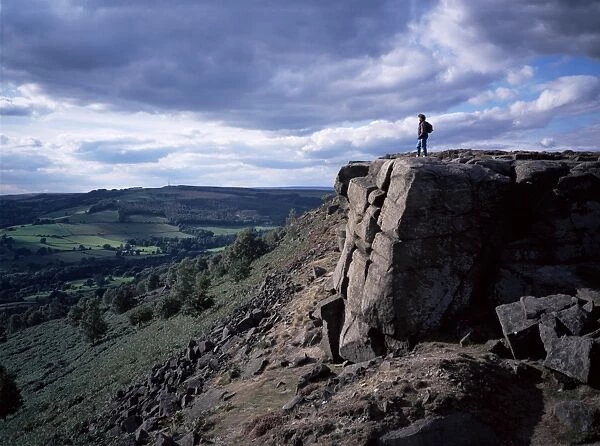 Walker on high rocks, Froggatt Edge, Derbyshire, England, United Kingdom, Europe