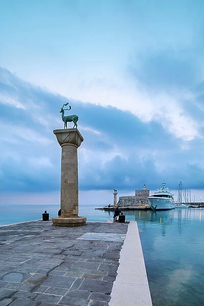 Dear and Doe on the columns at the entrance to the Mandraki Harbour, former Colossus of Rhodes location, Saint Nicholas Fortress in the background, dawn, Rhodes City, Rhodes Island, Dodecanese, Greece