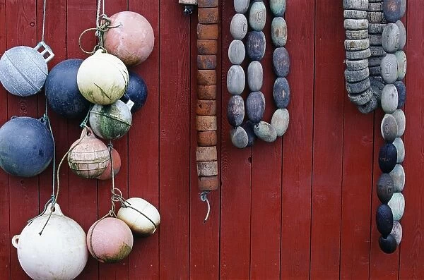 Fishing floats (or buoys) hanging on the side of a shack at