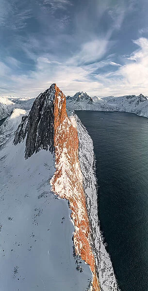 Overhead view of steep ridge of Segla mountain covered with snow at sunset, aerial view, Senja, Troms county, Norway