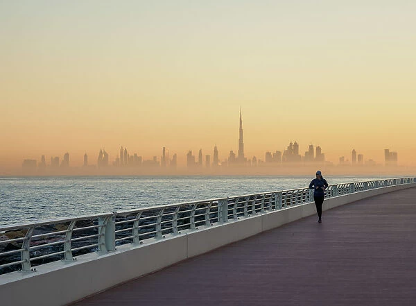Palm Jumeirah Boardwalk and City Centre Skyline at sunrise, Dubai, United Arab Emirates